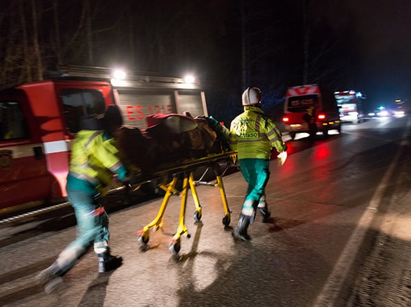 Patient on a gurney being taken to an ambulance at night