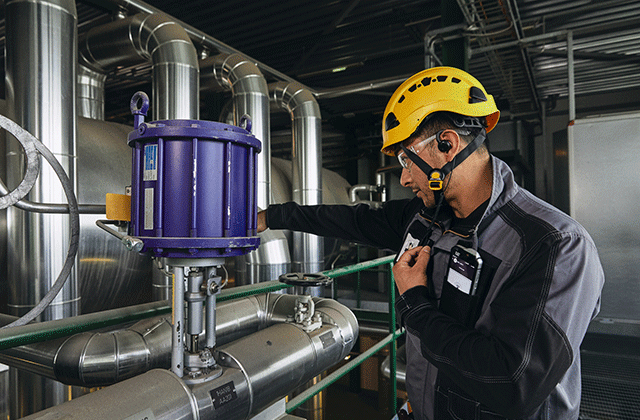 Industry worker using PTT services with accessories