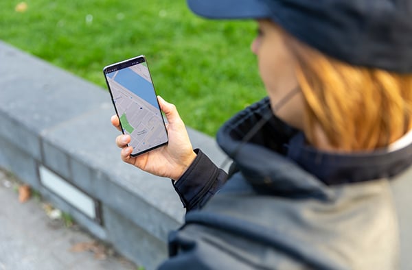 Security-woman-using-location-app-on-smartphone_600x394