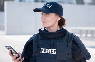 Police woman using a smartphone