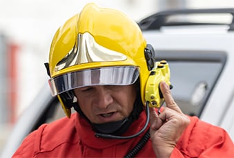 Fireman-with-helmet-and-PTT-accessory-339x229