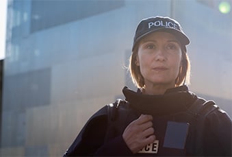 Female-police-officer-in-front-of-a-building-339x229