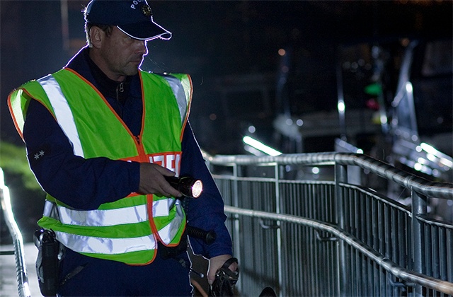 Police officer conducting a search at night