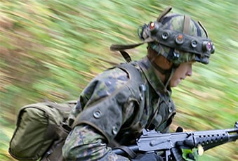 Soldier in camouflage gear, running fast