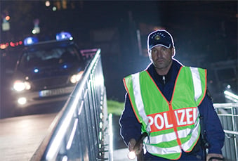 Police in a reflective vest at night