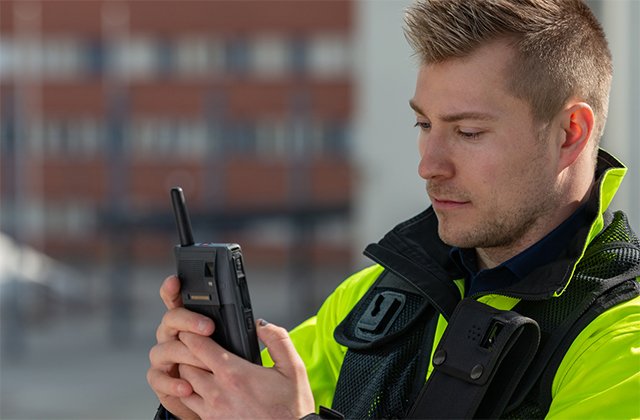 Industry worker with a rugged smartphone