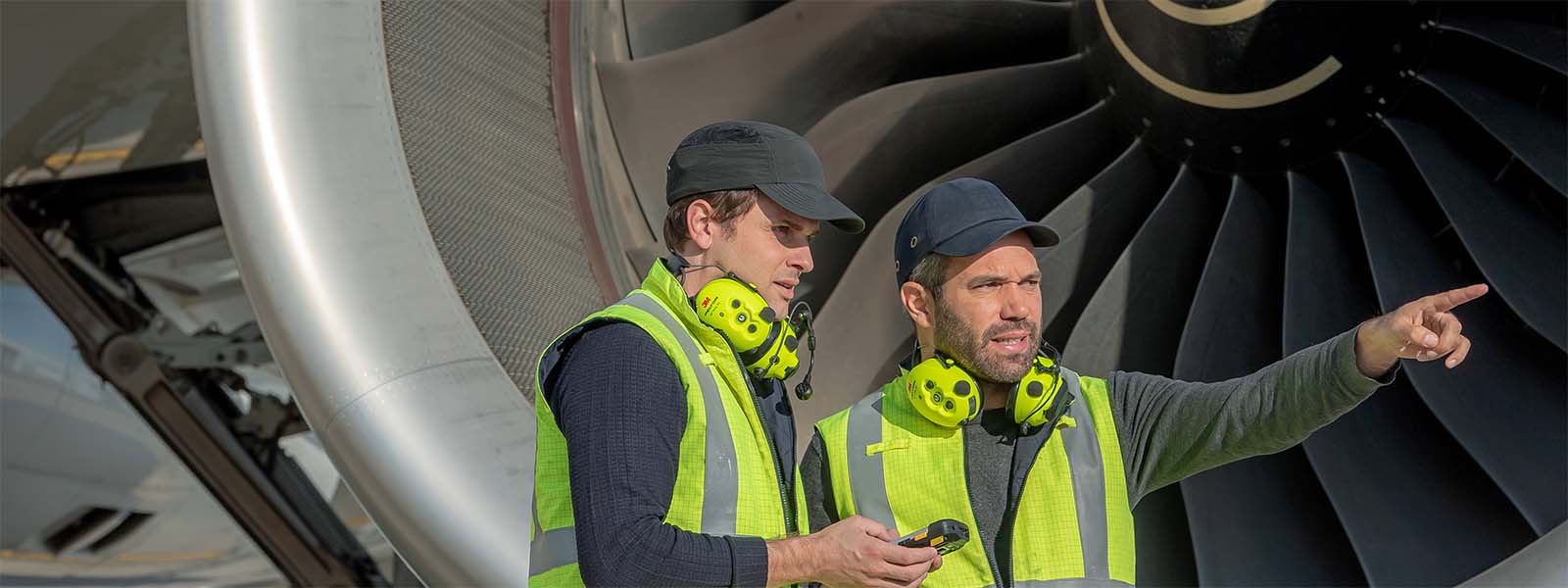 Two-aviation-professionals-in-front-of-an-airplane-1600x600
