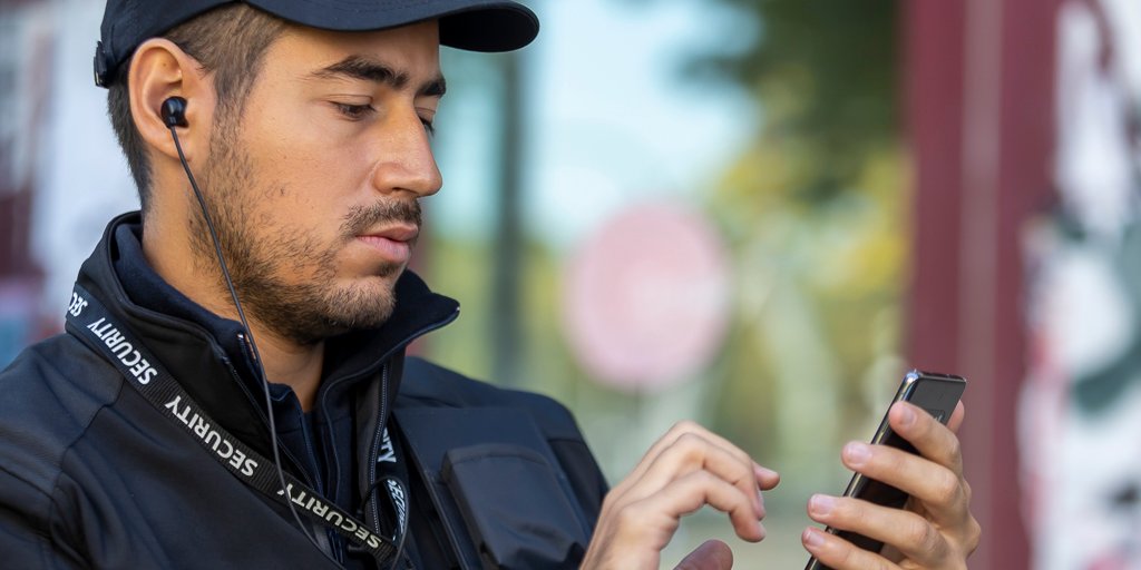 Security person using a smartphone